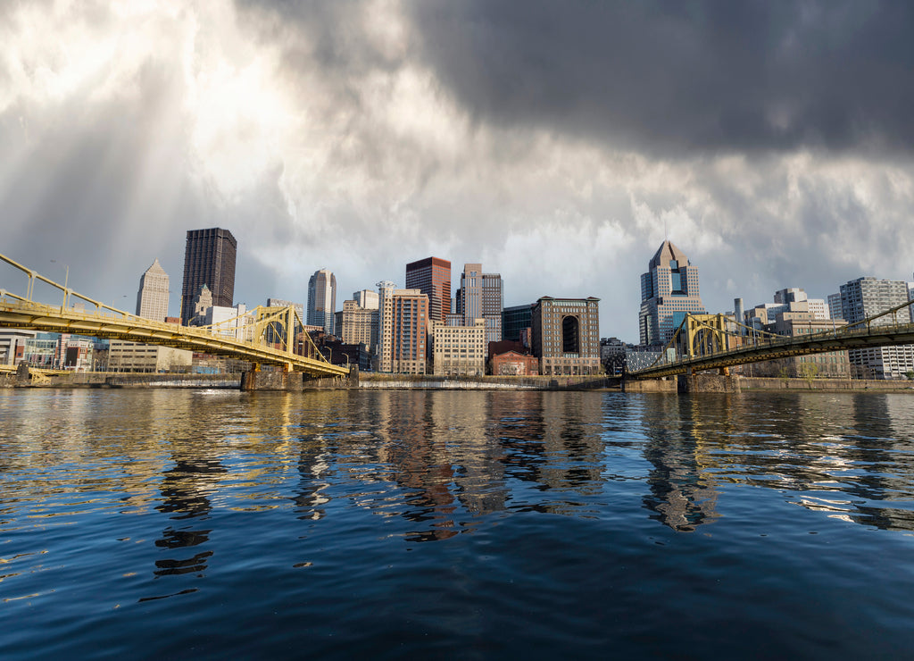 Downtown urban waterfront and bridges with stormy sky in Pittsburgh Pennsylvania