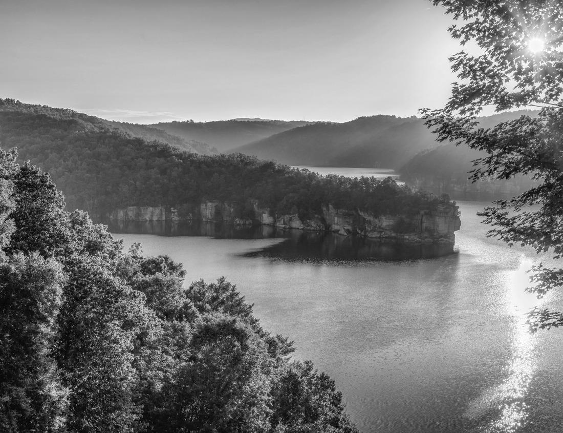 Noah Jigsaw Puzzle Landscape recreation area de Groene Weelde with view over water to pyramidal hill Big Spotters Hill between Hoofddorp and Vijfhuizen on dark sky and low sun in black white 1000 pieces