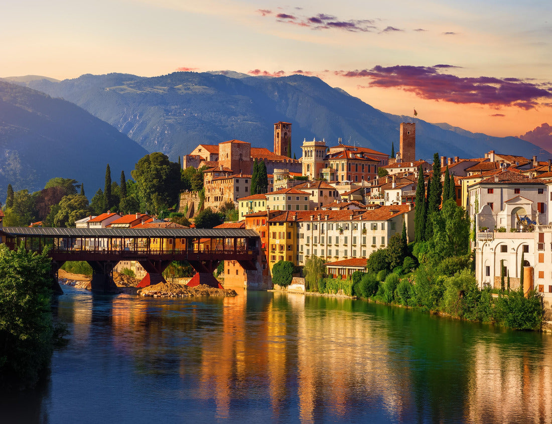 Noah Jigsaw Puzzle Bassano del Grappa, Veneto, Italy. Ponte degli Alpini bridge on the Brenta river. Panoramic view of the old town with vintage tower, wooden bridge on the Alpine mountains, picturesque sunset landscape 1000 pieces