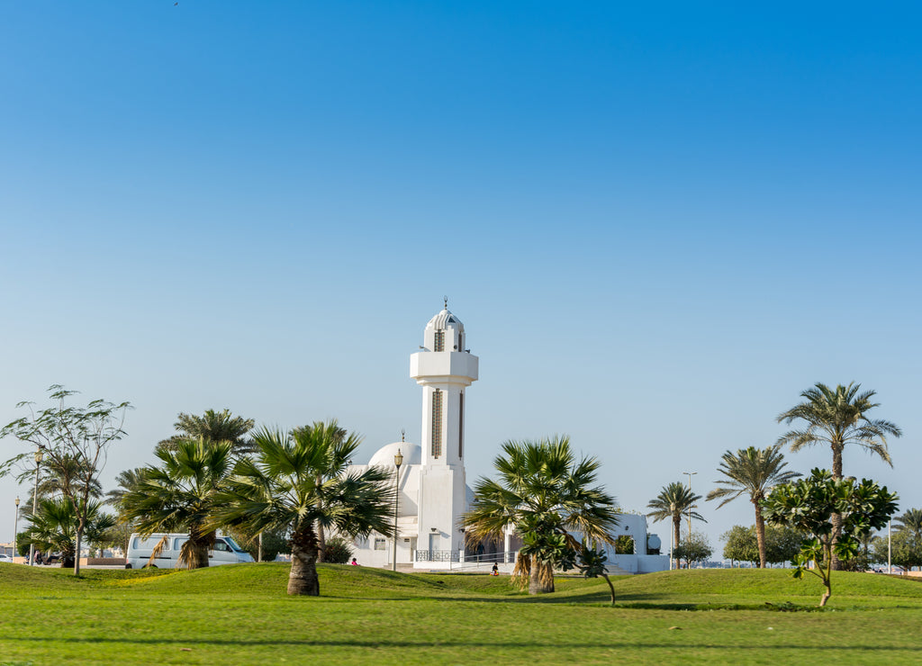 A common small mosque, Al Essa and Al Dowayan Mosque, with palm tree in the corniche coastal park in Dammam, Kingdom of Saudi Arabia