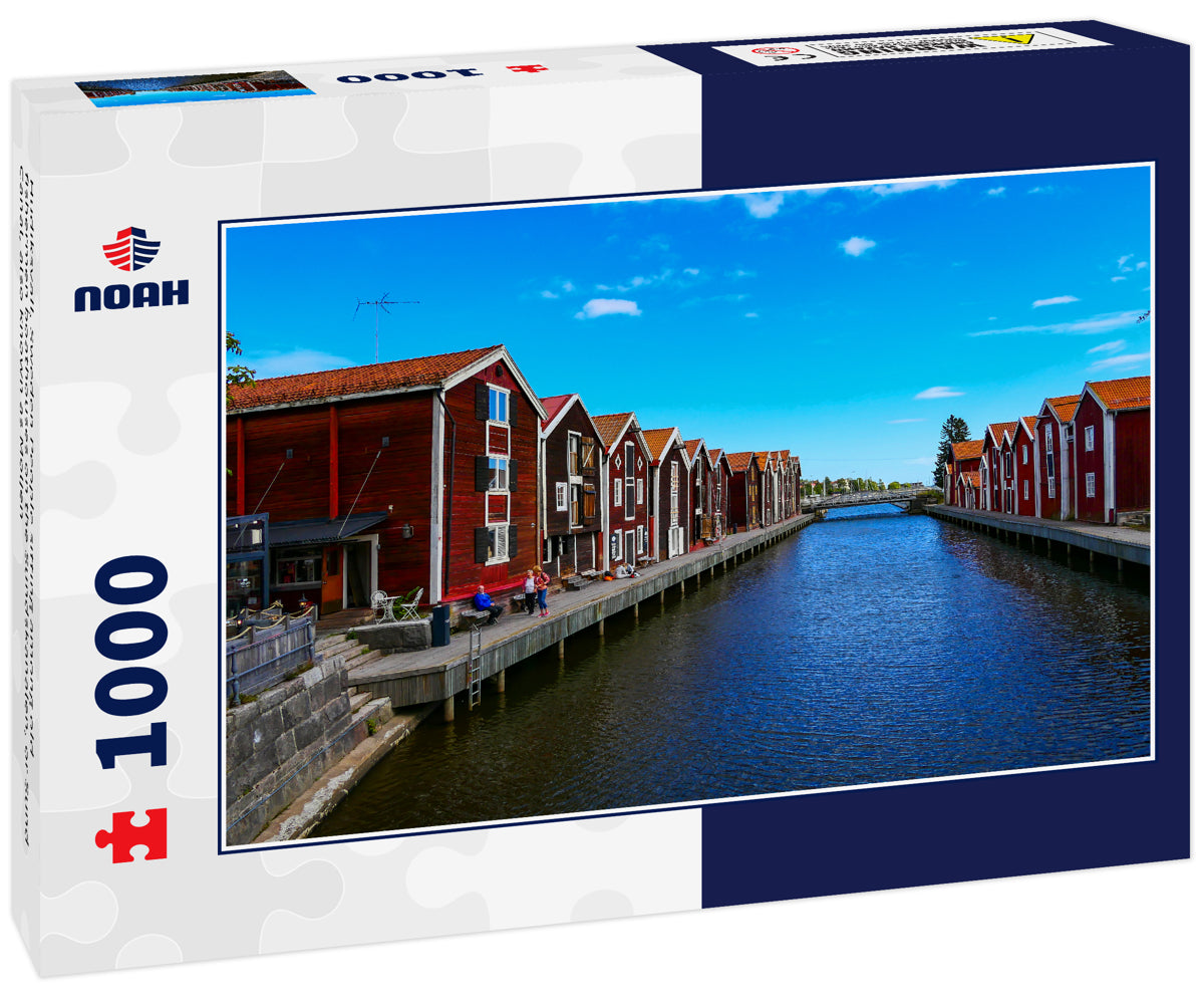 Hudiksvall, Sweden People sitting among old fishermen boathouses on the Sundskanalen, or Sund Canal, also known as Moljen