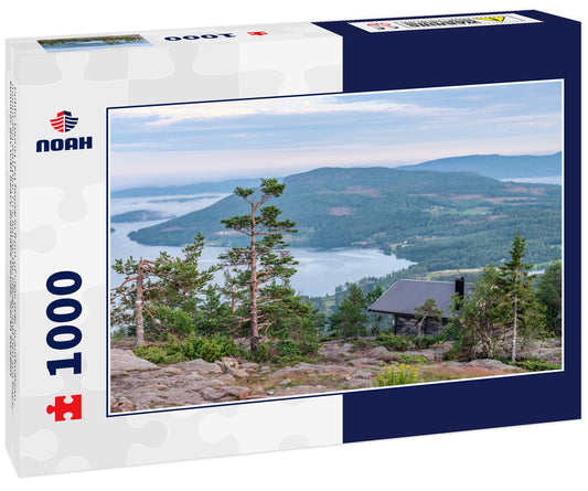 Public tourist rest house in front of view over Scandinavian mountains with pine tree forest, the village and two sea bays, summer day with heavy dramatic clouds, North Sweden