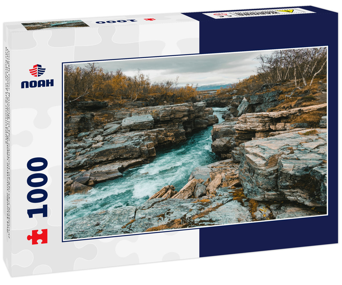 rough river flowing in the canyon of Abisko National Park in polar Sweden in golden autumn against the backdrop of the mountains