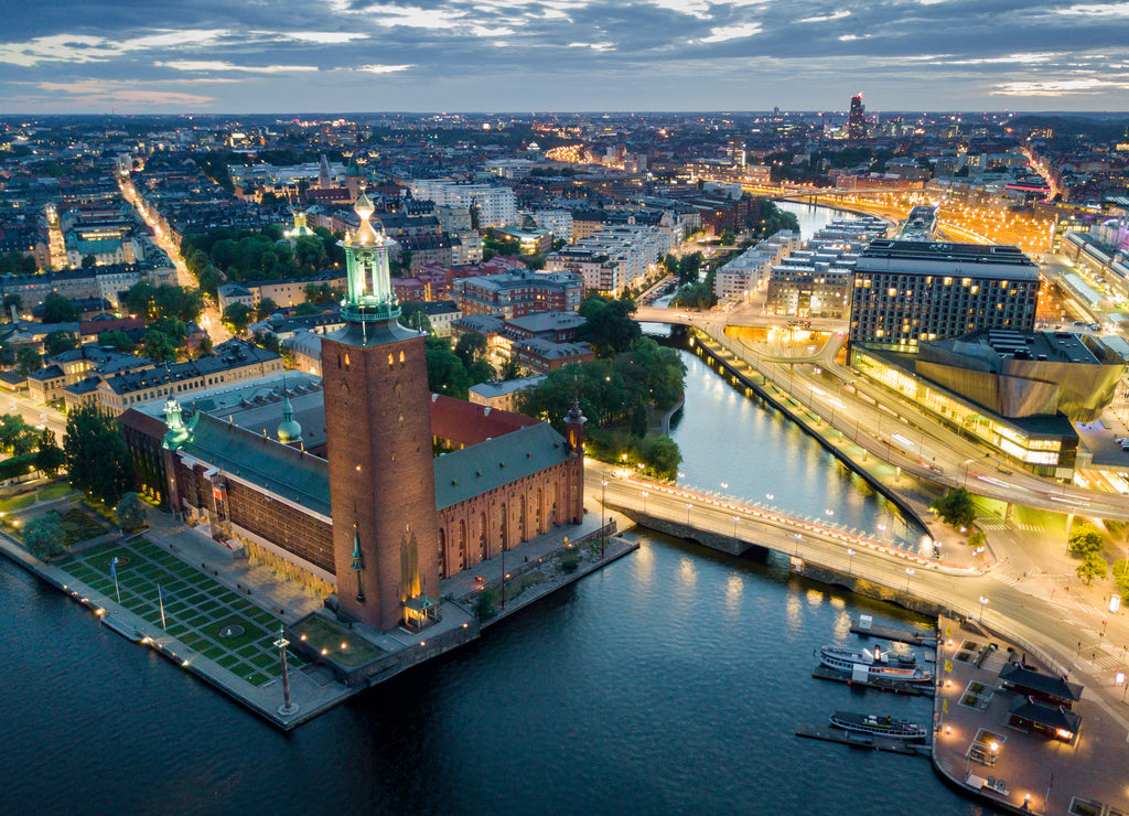 Aerial view of Stockholm city hall and illuminated cityscape at night in Stockholm, Sweden