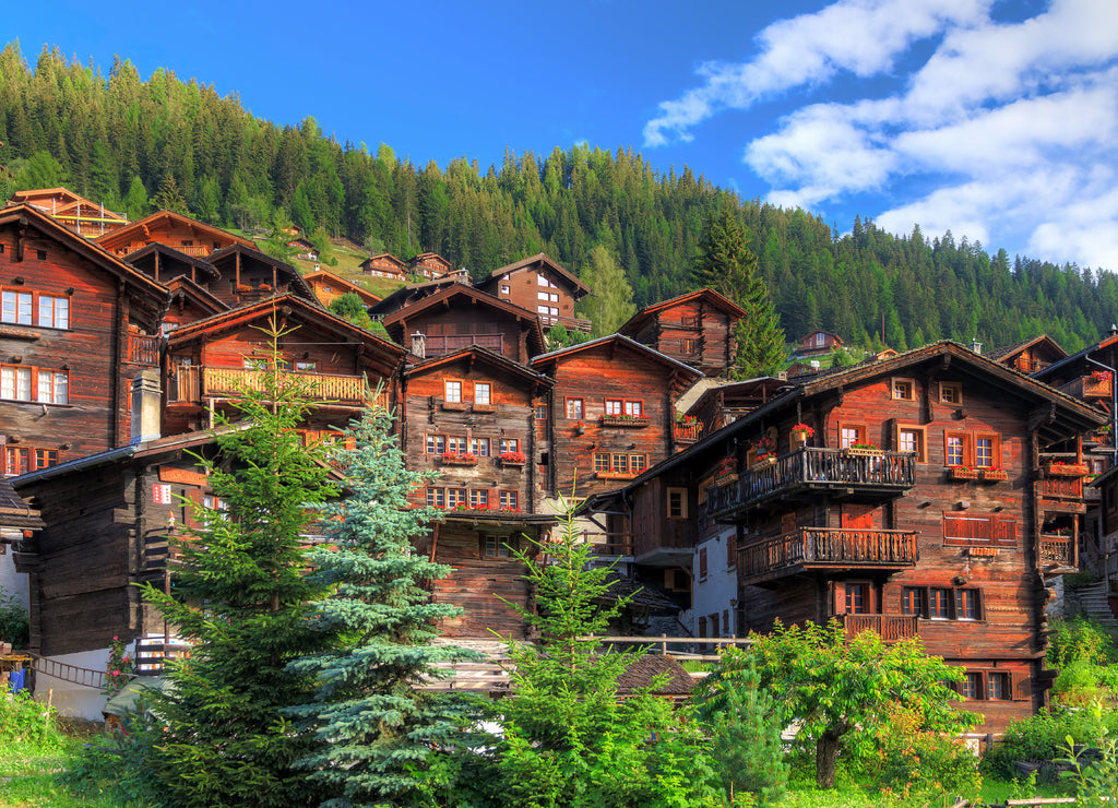 Beautiful cityscape of the alpine village Grimentz, Switzerland, with traditional wooden houses in summer