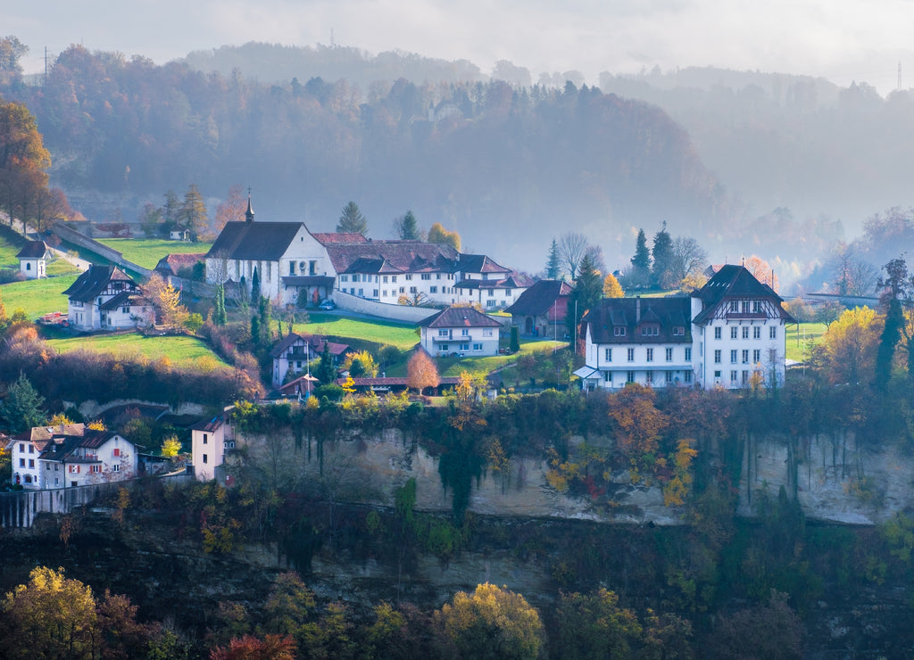 A beautiful and colorful foggy autumn landscape around the historic city of Fribourg, Switzerland