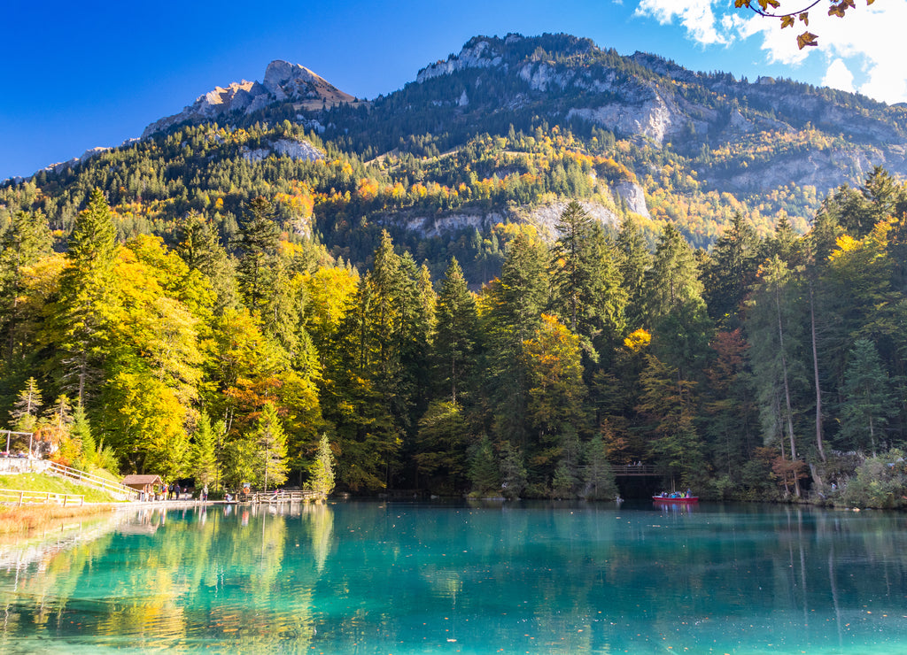 Nature park Blausee or blue lake in Kandersteg, Switzerland, autum color with clear water