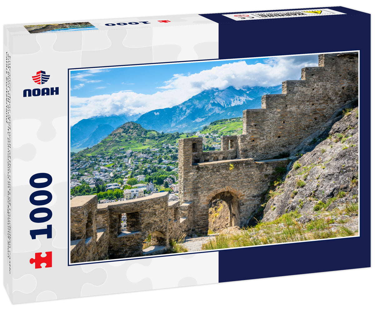 Entrance door and wall of the ruins of Tourbillon castle and Sion hill and city panorama in background Sion Valais Switzerland