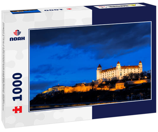 Night view of Bratislava castle from river surface with dramtic sunset skyline, Slovakia