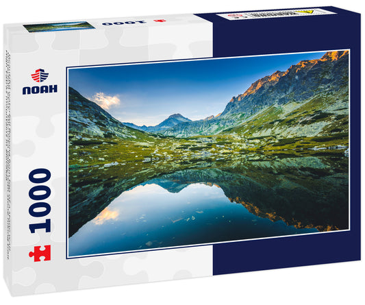 Beautiful waterfall flowing from top of a stone wall. Waterfalll Skok. Mlynicka valley with stone hiking trail. High Tatras mountains in Slovakia