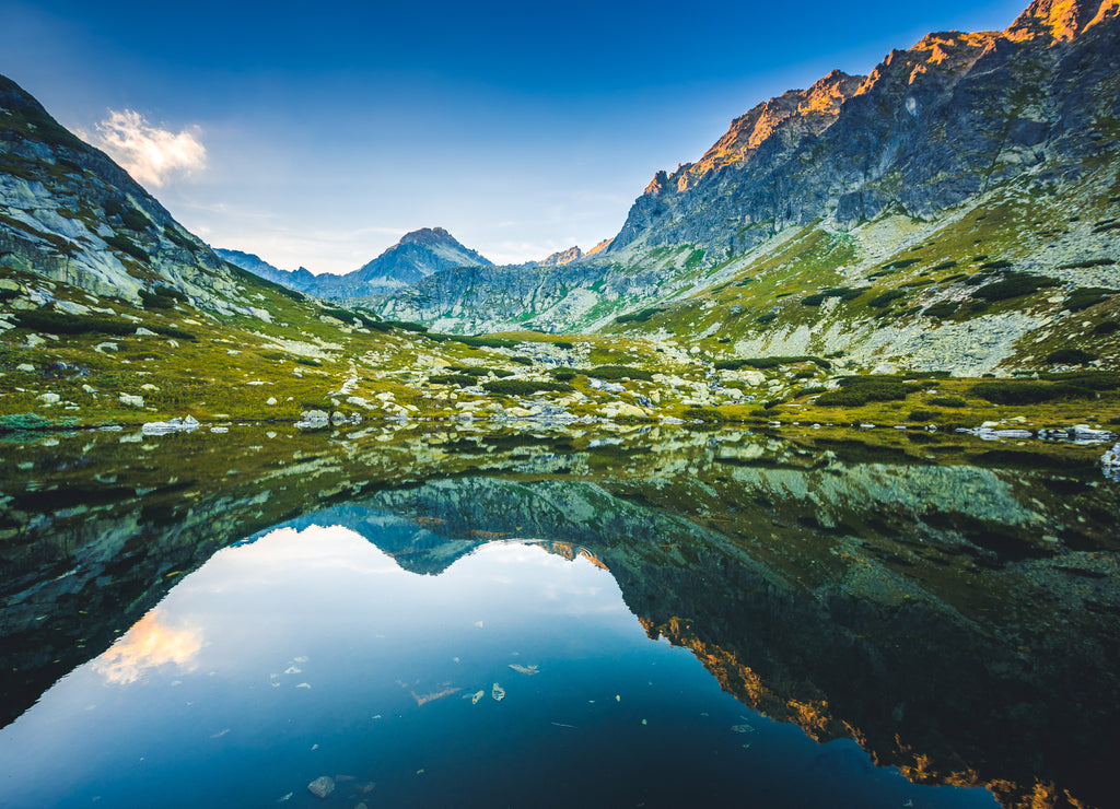 Beautiful waterfall flowing from top of a stone wall. Waterfalll Skok. Mlynicka valley with stone hiking trail. High Tatras mountains in Slovakia