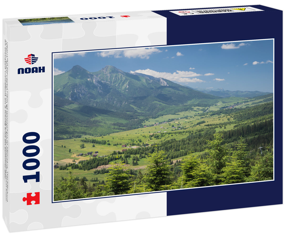 Beautiful elevated view of mountains in Slovakia. Bachledova dolina, Zdiar village and Belianske Tatry mountains seen from an elevated viewpoint on a hiking trail on summer day