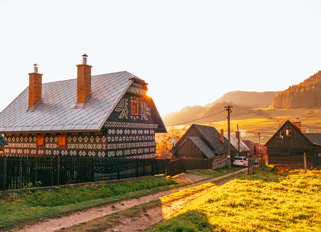 Old wooden houses in Slovakia village Cicmany in autumn. Unique decoration of log houses based on patterns used in traditional embroidery in village of Cicmany, UNESCO World Heritage Site, Slovakia