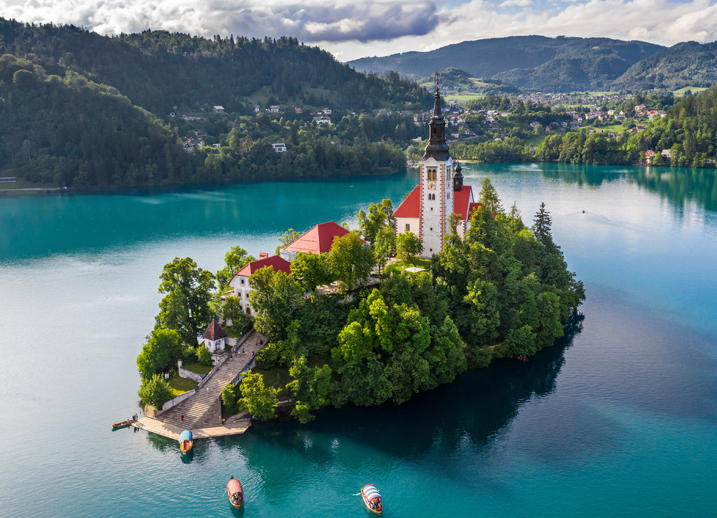 Bled, Slovenia - Beautiful morning at Lake Bled (Blejsko Jezero) with the Pilgrimage Church of the Assumption of Maria and traditional Pletna boats