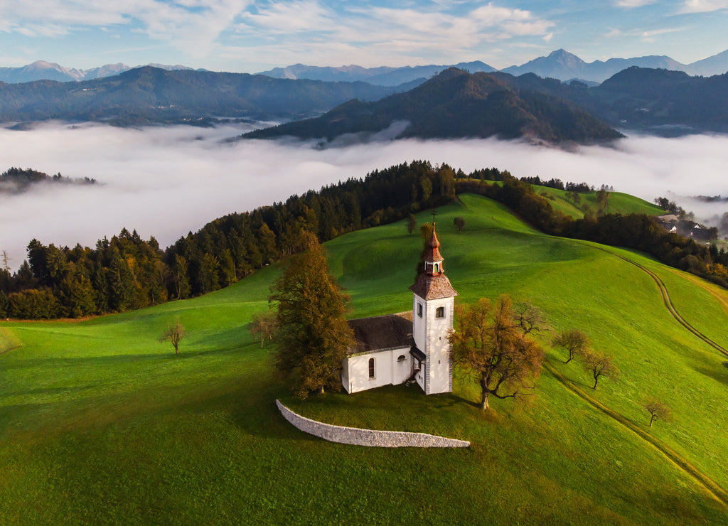 Autumn landscape of a beautiful church on the top of a hill, in Slovenia