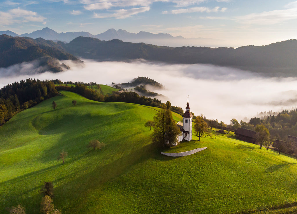 Autumn landscape of a beautiful church on the top of a hill, in Slovenia