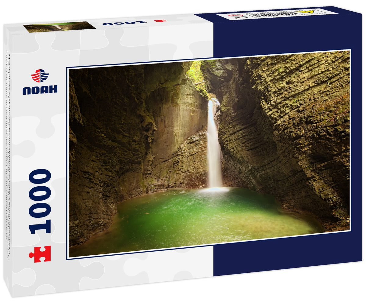 Mystical view of the rocky amphitheatre with a green pool and a white beam of water. 15-metre-high Kozjak Waterfall (Slap Kozjak). Protected natural treasure. National Park of Triglav, Slovenia