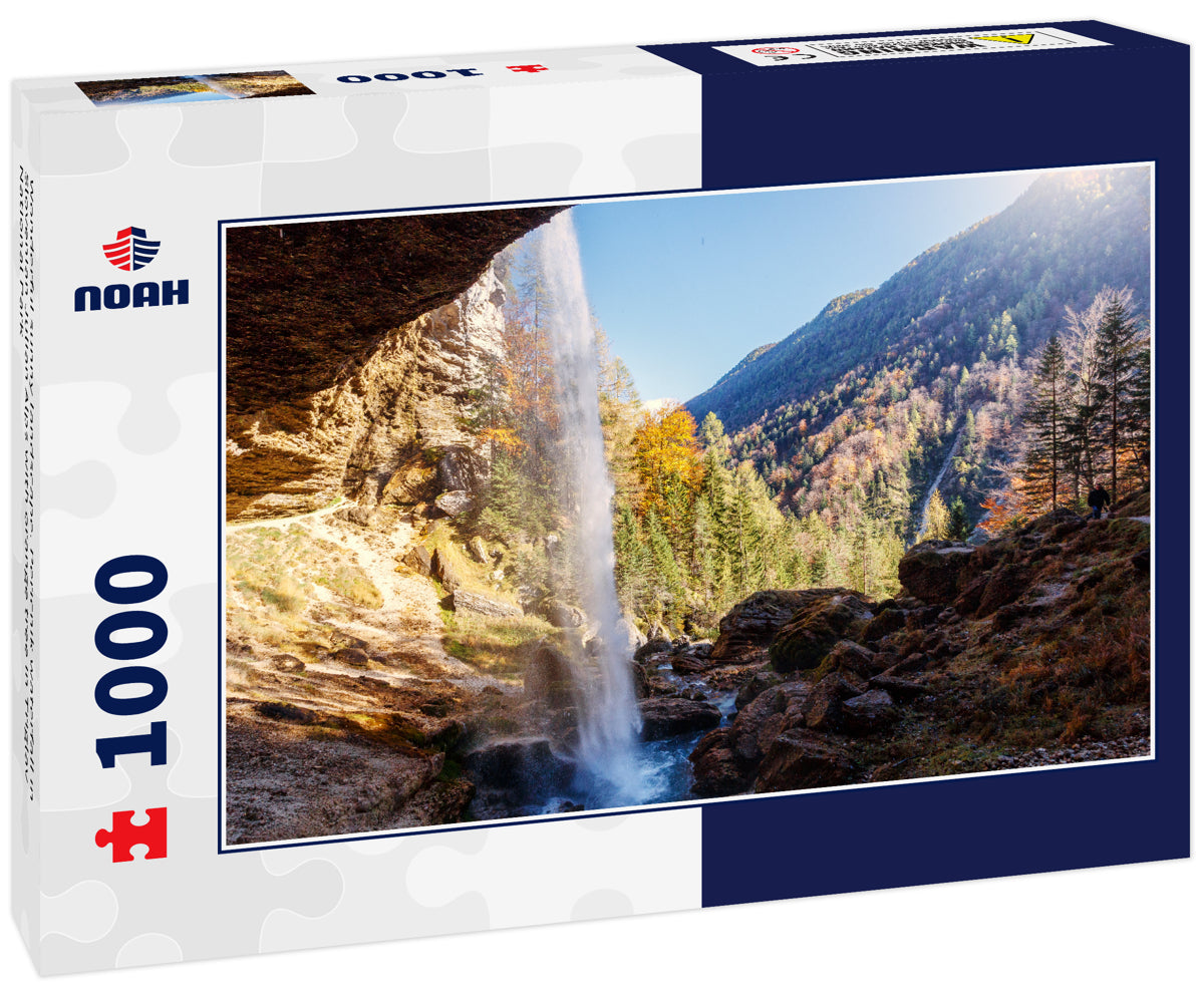 Wonderful sunny landscape. Pericnik waterfall in Slovenian Julian Alps with orange tree in Triglav National Park