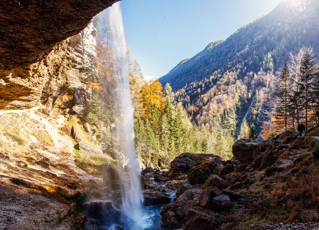 Wonderful sunny landscape. Pericnik waterfall in Slovenian Julian Alps with orange tree in Triglav National Park