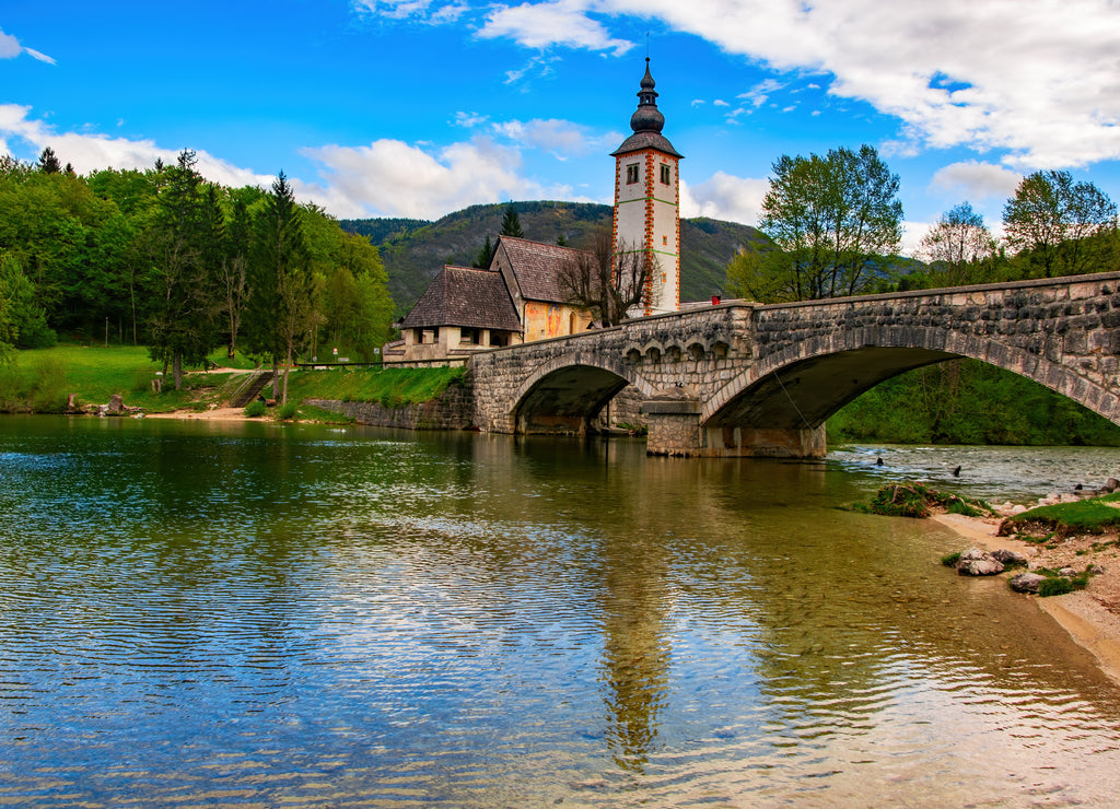 Scenic view of stone bridge and church of St John the Baptist on Bohinj Lake, Slovenia