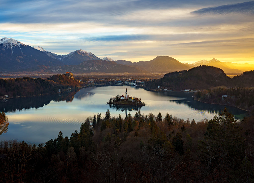 Aerial view of Lake Bled and Julian Alps, with Pilgrimage Church of the Assumption of Maria at sunrise, Slovenia
