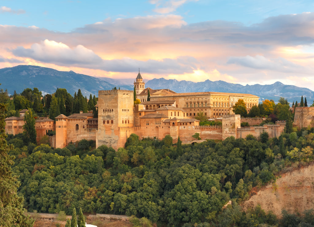 Palace and fortress complex Alhambra with Comares Tower, Palacios Nazaries and Palace of Charles V during sunset in Granada, Andalusia, Spain