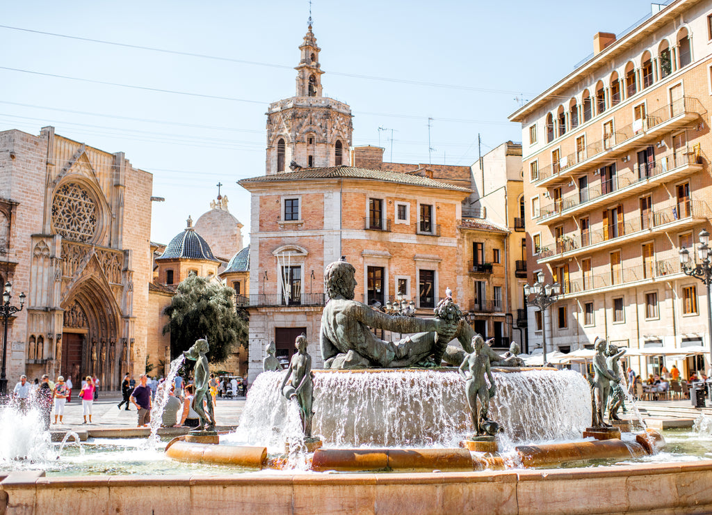 View in the Virgen square with cathedral and fountain in the centre of Valencia city during the sunny day in Spain