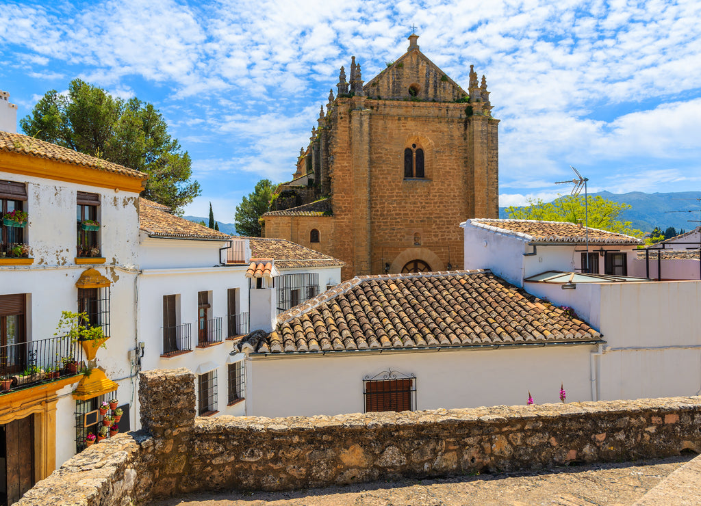 Church in Ronda village with white houses, Andalusia, Spain