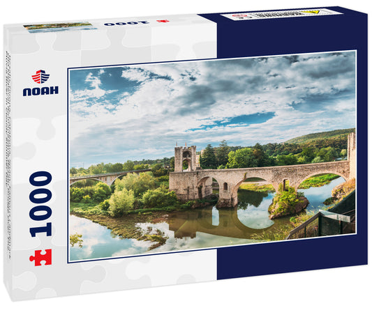 Besalu, Girona, Catalonia, Spain. Famous Landmark Old Medieval Romanesque Besalu Bridge Over The Fluvia River In Cloudy Summer Day