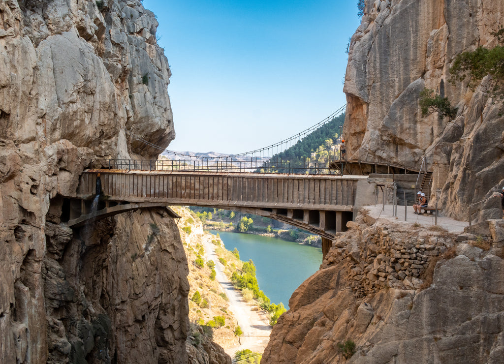 El Chorro, Spain. El Caminito del Rey walkway along the steep walls of a narrow gorge in El Chorro with spectacular old stone bridge joining vertical rocks, Spain