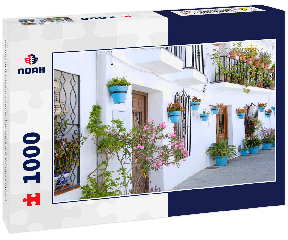 Picturesque street of Mijas with flower pots in facades, a traditional whitewashed village, Spain