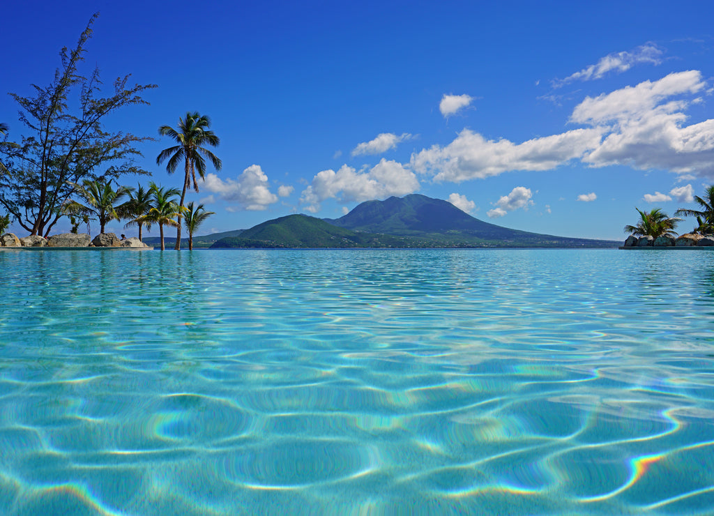 View of the Nevis Peak volcano from a swimming pool in Christopher Harbour, St Kitts