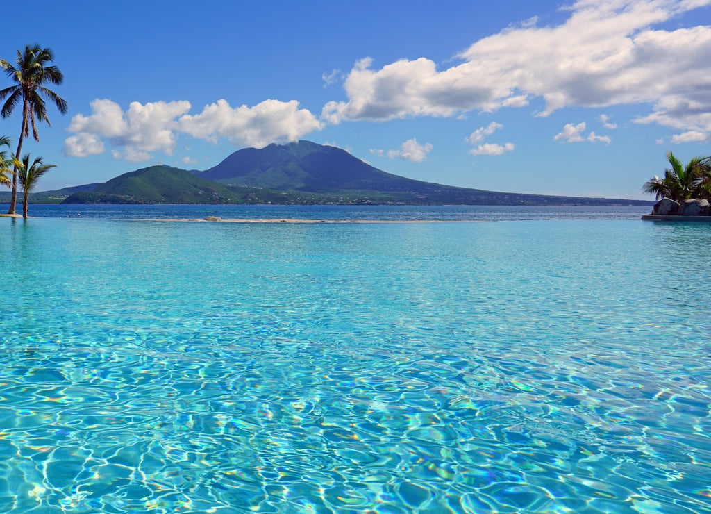 View of the Nevis Peak volcano from a swimming pool in Christopher Harbour, St Kitts