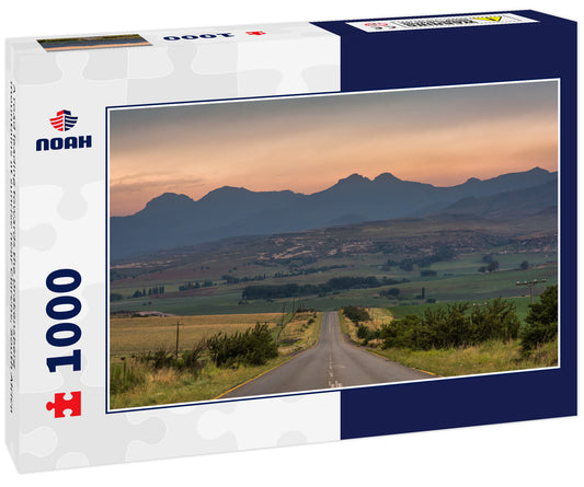 A road leading towards the Drakensberg mountains at sunrise near Clarens, South Africa