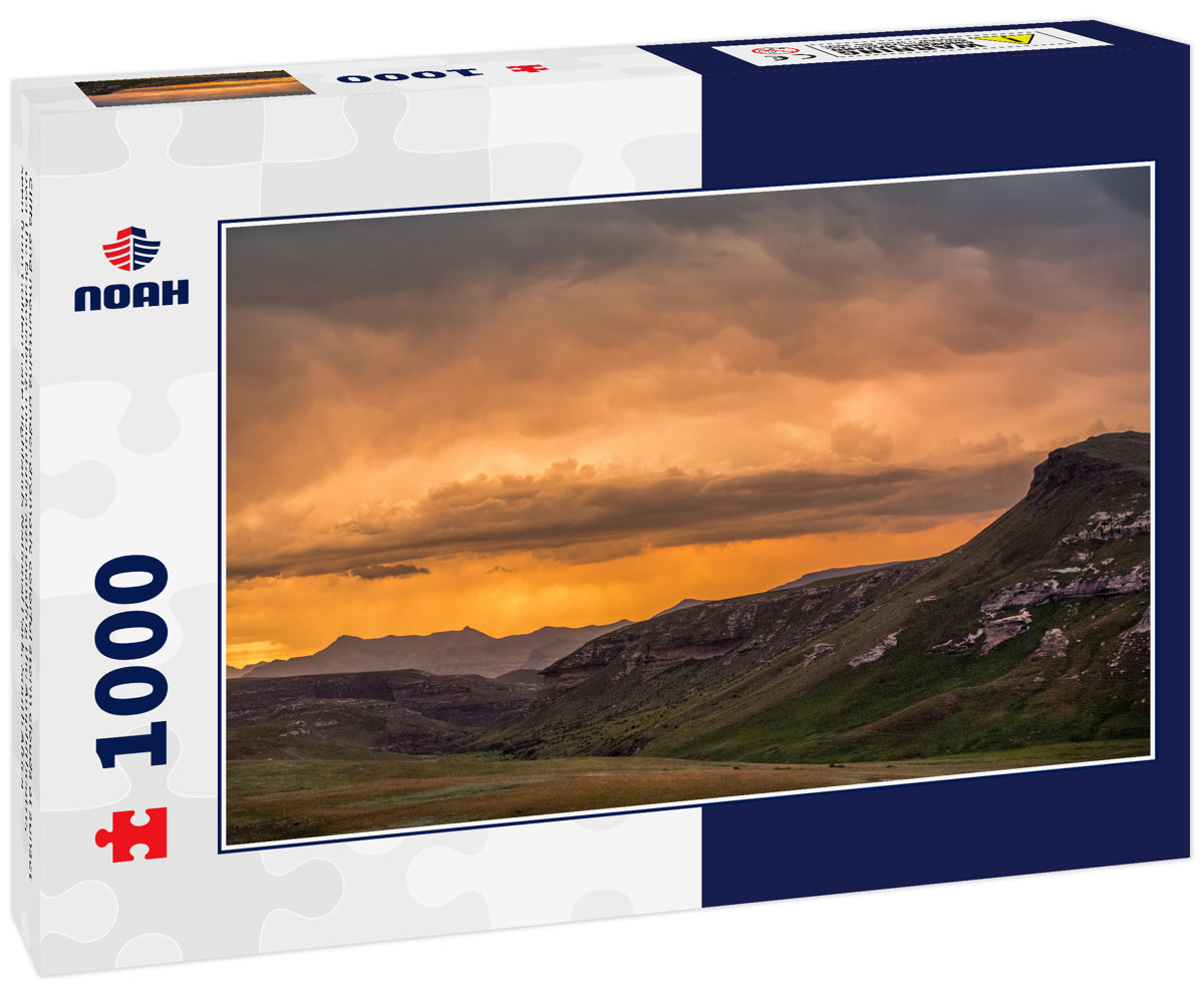 Cliffs and mountains under dramatic colorful storm clouds at sunset over the Drakensberg mountains surrounding the Amphitheatre, seen from Golden Gate Highlands National Park, South Africa