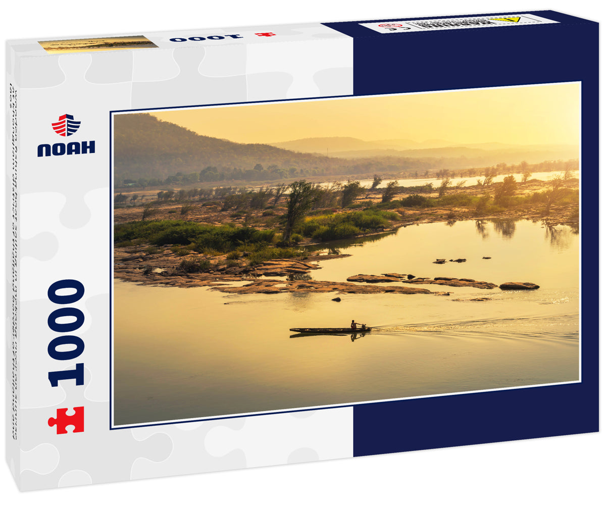 wooden fishing boat sailing in mekong river on sunrise at khongjiam district of thailand border of thailand and laos