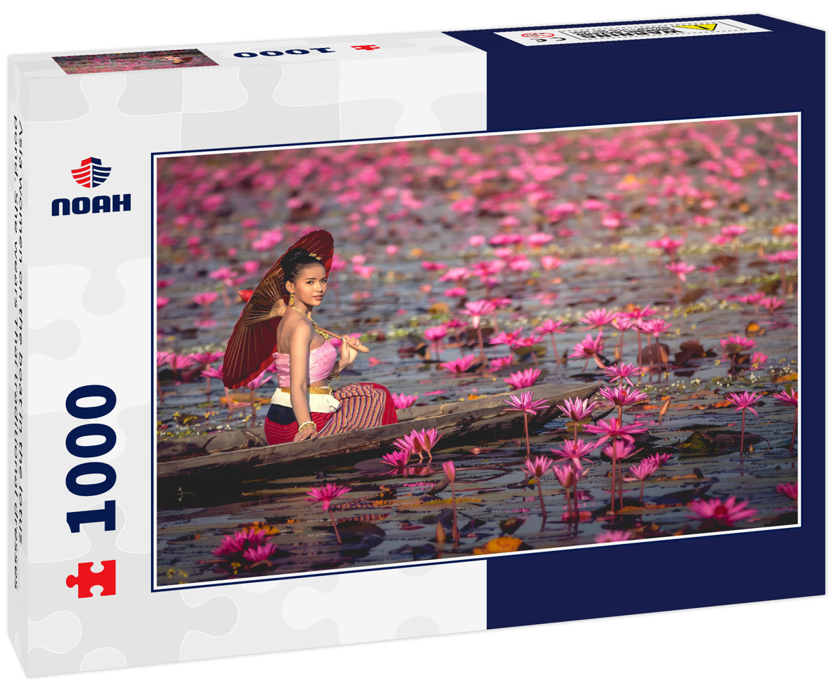 Asia women on the boat in the lotus pond. She wears Thai traditional dresses