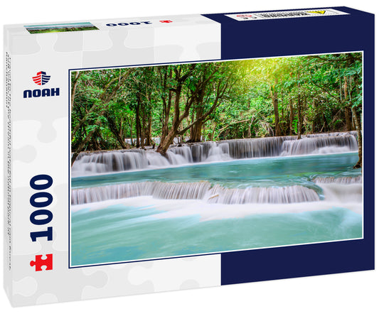 Travel to the beautiful waterfall in tropical rain forest, soft water of the stream in the natural park at Kanchanaburi