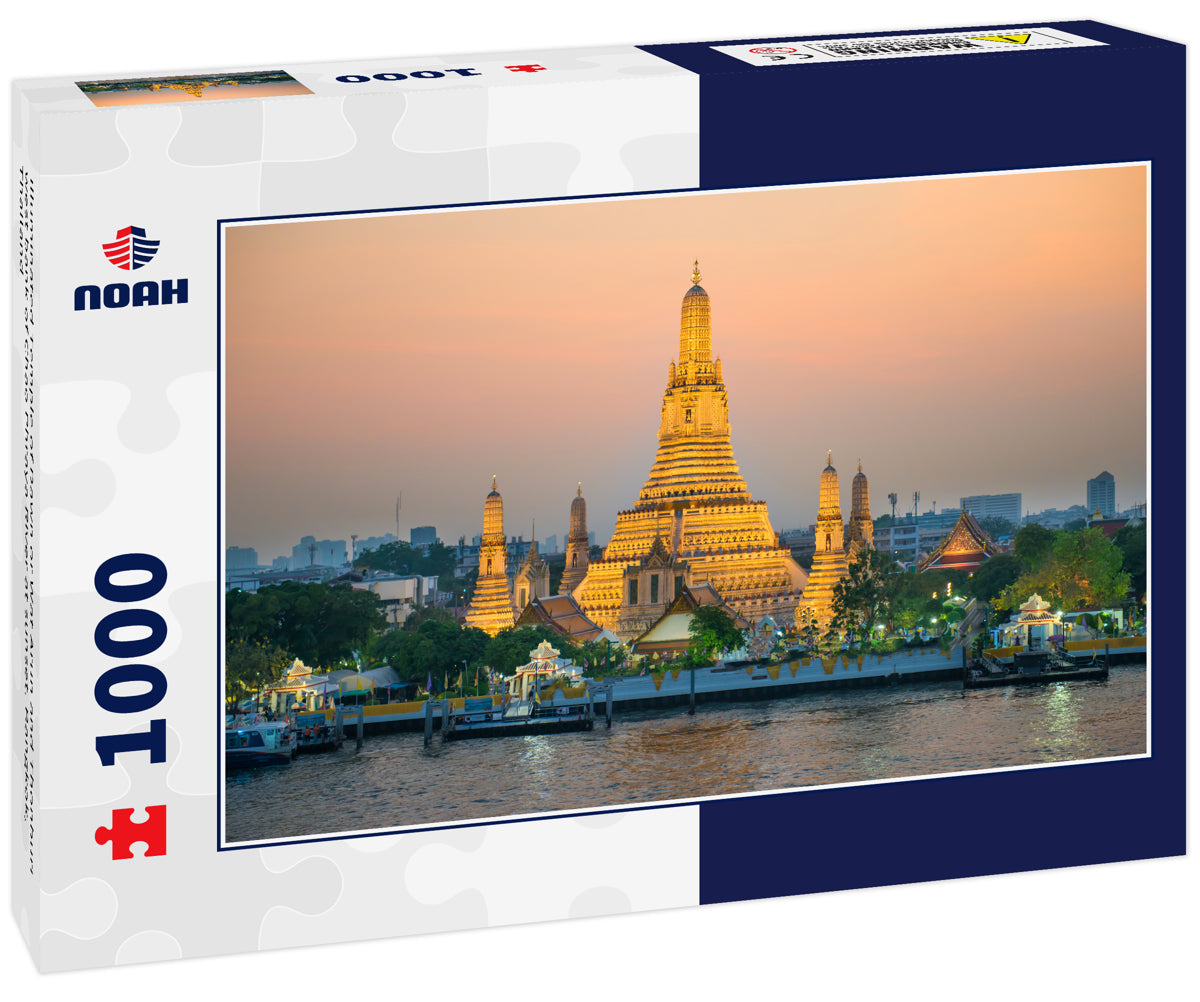 Illuminated Temple of Dawn or Wat Arun and Thonburi west bank of Chao Phraya River at sunset. Bangkok, Thailand