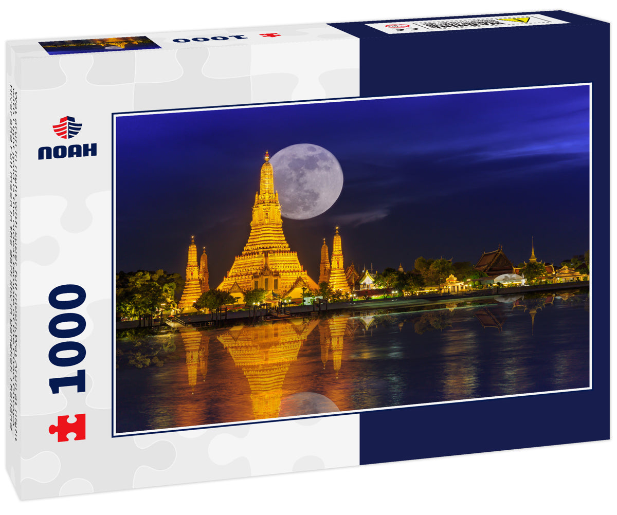 Wat arun in night with super full moon,Wat Arun at night with Light gold is the oldest temple of the Chao Phraya River and Full moon In the dark sky in Bangkok Thailand
