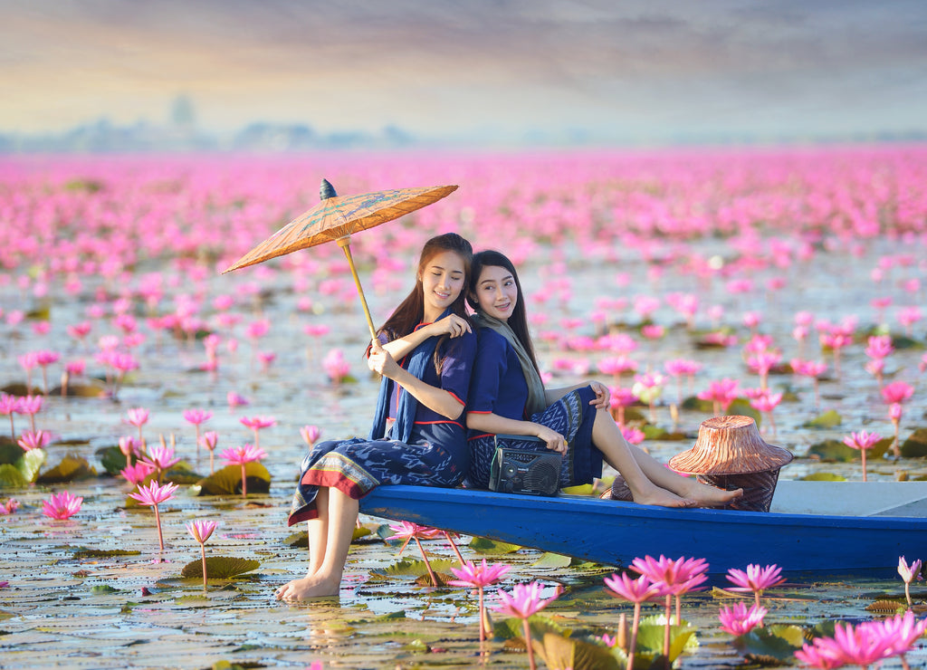 Asian woman wearing traditional thai culture, vintage style, Lake of pink lotus, Thailand