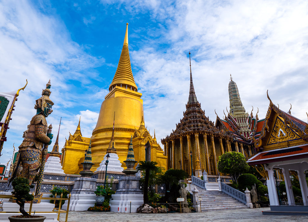 Beautiful landscape of Wat Phra Si Rattana Satsadaram (Wat Phra Kaew) or Temple of the Emerald buddha over blue sky and white cloud. Most popular temple of tourist in Bangkok, Thailand