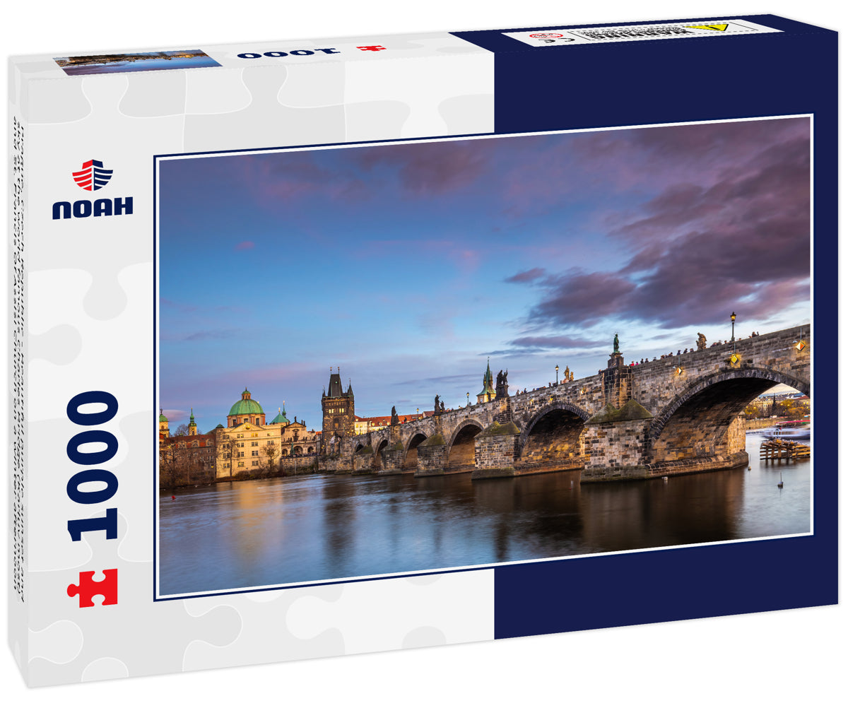 Prague, Czech Republic - Beautiful purple sunset and sky at the world famous Charles Bridge (Karluv most) and St. Francis Of Assisi Church on a winter afternoon