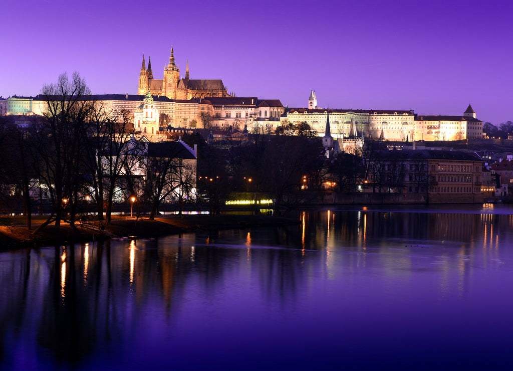 Panoramic view To Hradschin Castle, St. Vitus Cathedral And Charles Bridge In Prague, Czech Republic during sunset with dramatic sky