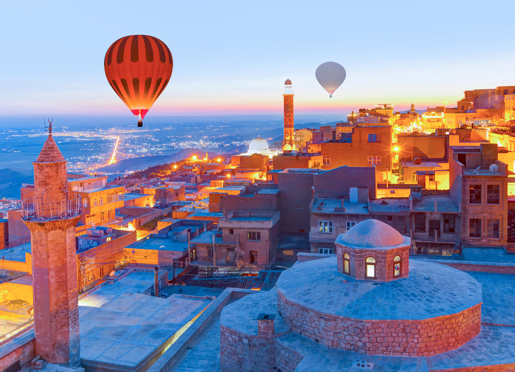 Hot air Balloon flying over Mardin old town - Mardin old town at twilight blue hour - Mardin, Turkey