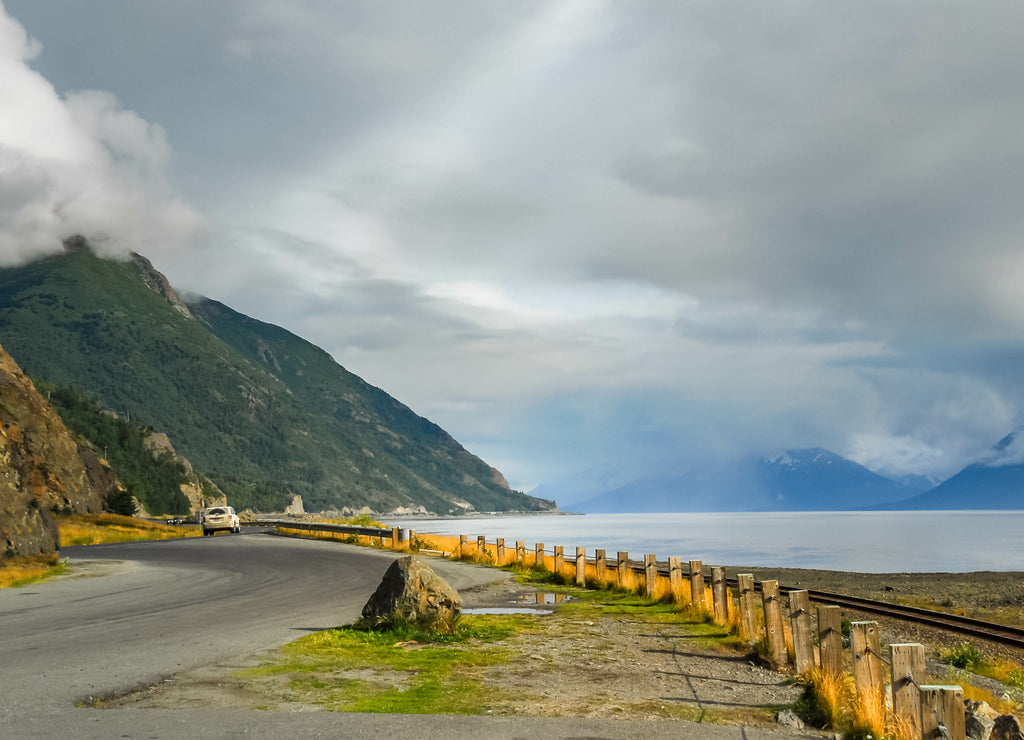 Alaska road along water at Turnagain Arm with clouds