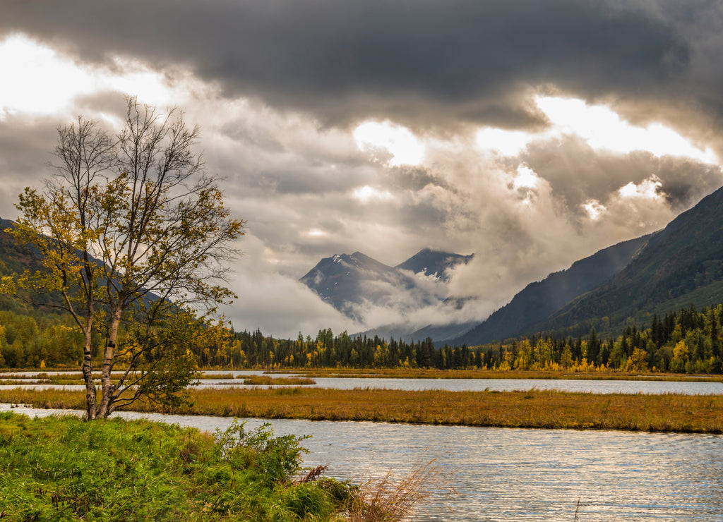 dramatic autumn landscape photo of mountain peaks and calm lakes in the Kenai Peninsula in Alaska