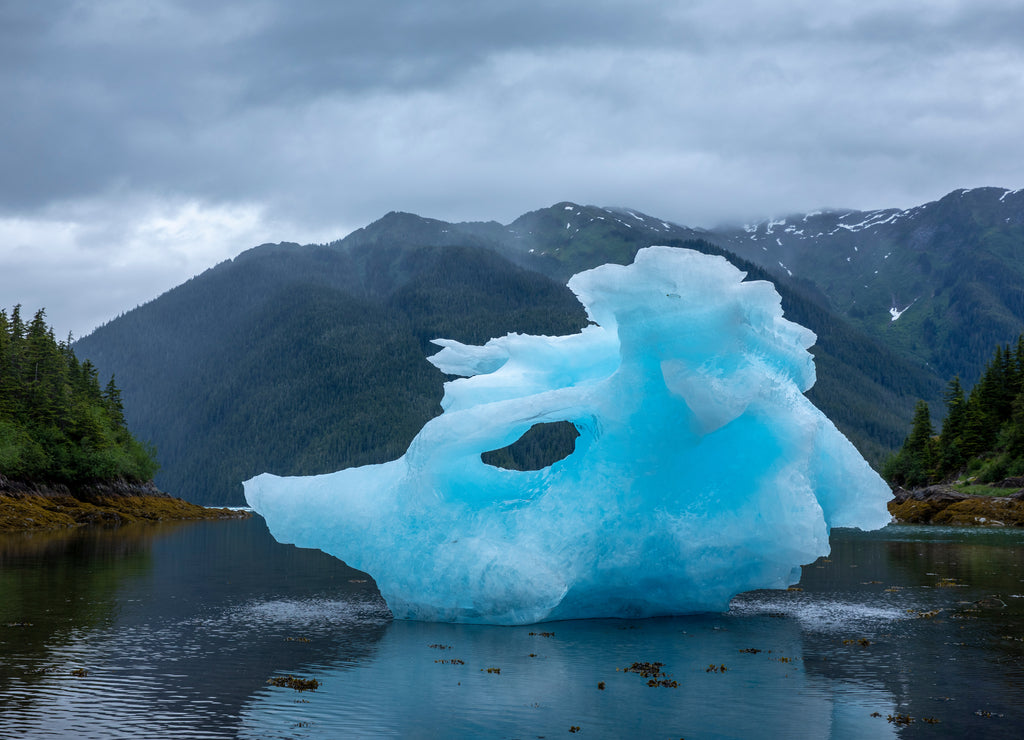 USA, Alaska, Petersburg, Large iceberg from LeConte Glacier grounded at low tide in LeConte Bay on summer evening