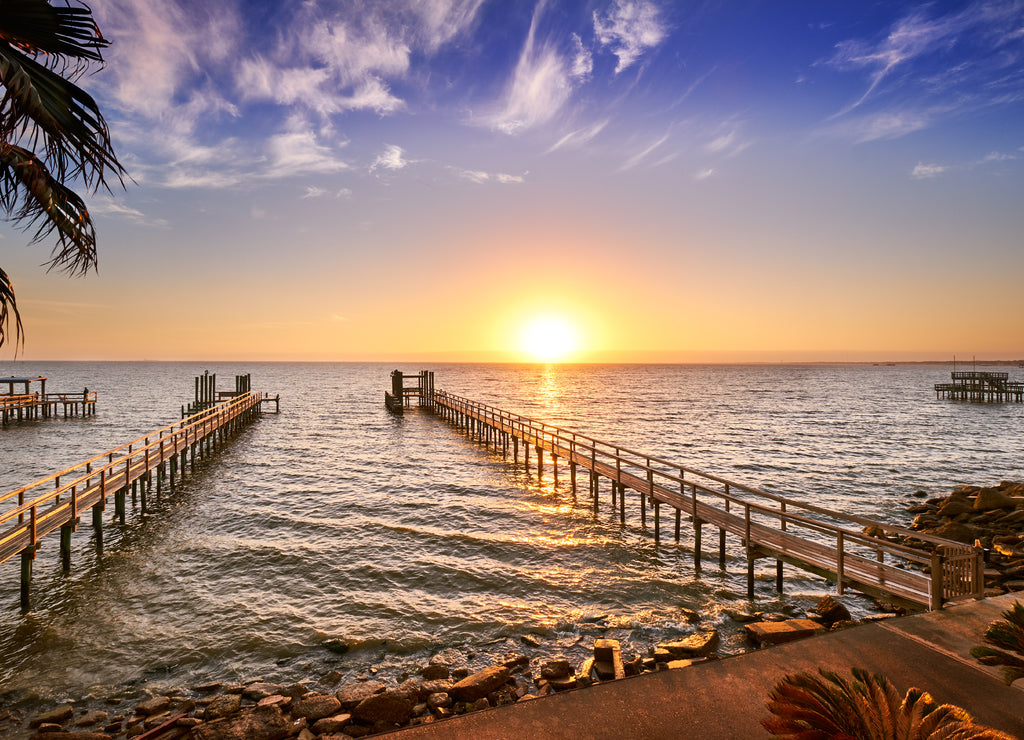 Long wooden fishing docks stretch out into Galveston Bay, Texas