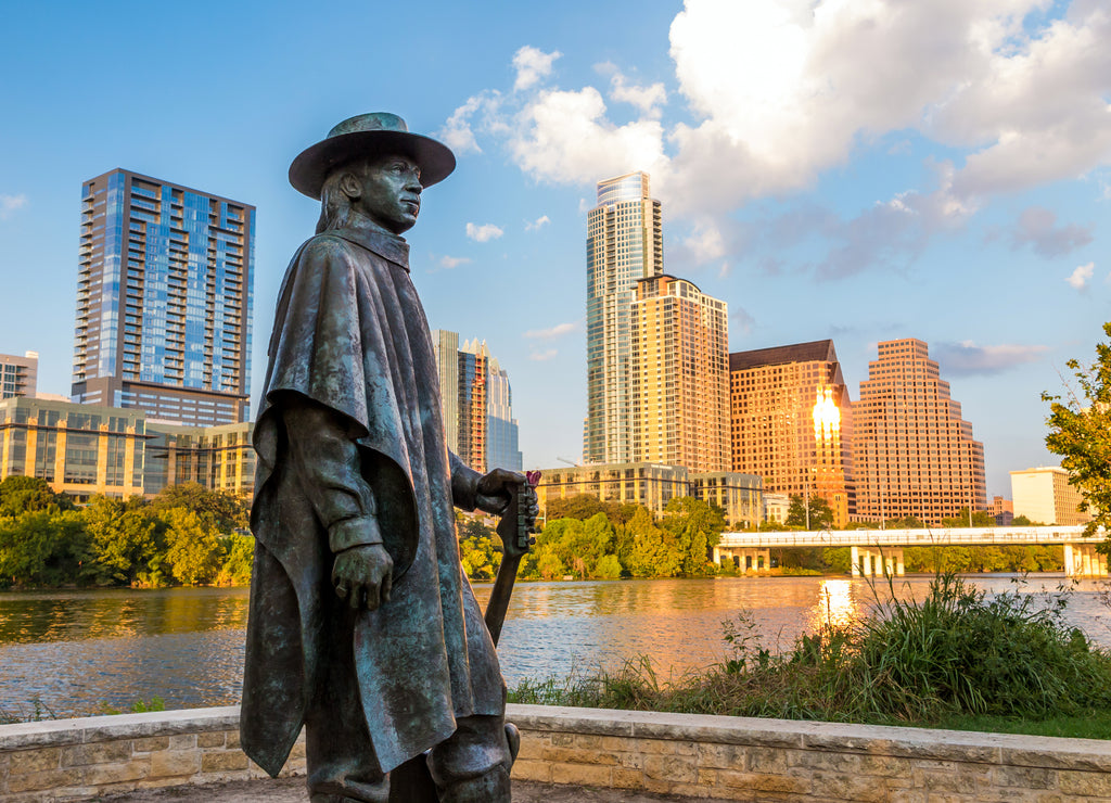 Stevie Ray Vaughan statue in front of downtown Austin and the Co, Texas